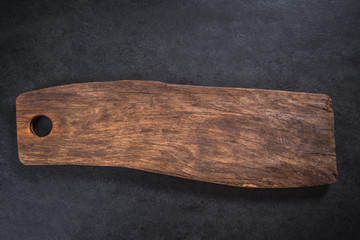 rustic chopping board on dark slate