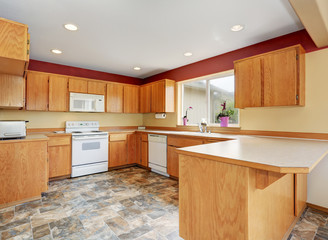 Classic kitchen room interior with tile floor and wooden cabinets