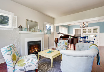 Modern living room interior with fireplace and piano at the background.