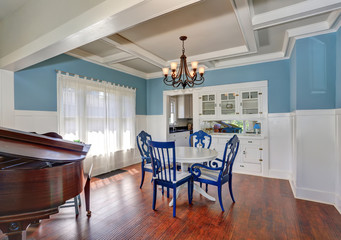 Blue and white dining area with nice table set.
