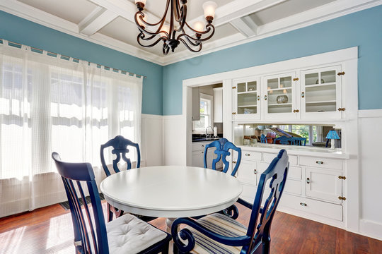 Blue and white dining area with nice table set.