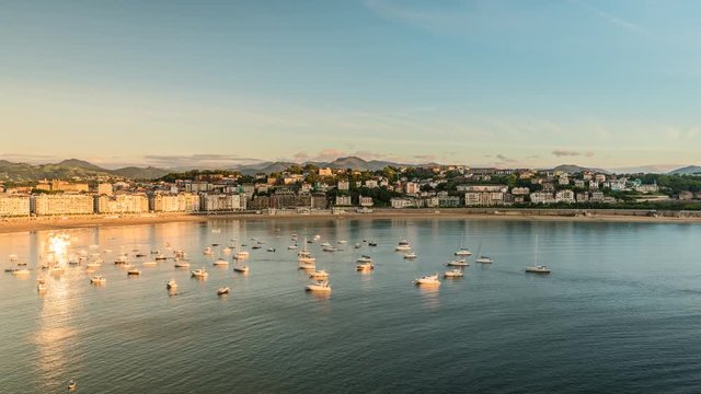 San Sebastian Concha Bay at sunset, Spain. Time Lapse with boats on the ocean