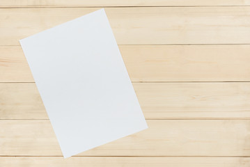 Blank white paper on wooden panel background