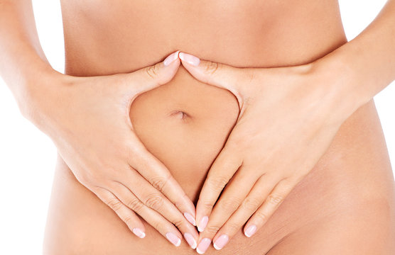Hands on slim female belly