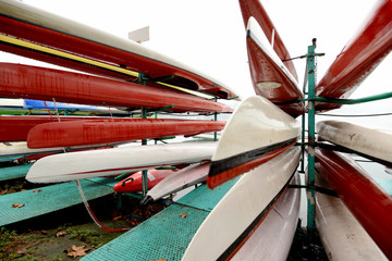 Colorful Kayaks and canoes in a Row stack