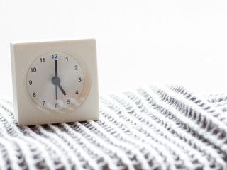 Fototapeta na wymiar Series of a simple white analog clock on the blanket, 1/15