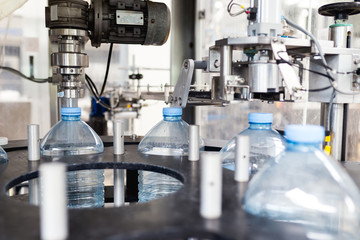 Water factory - Water bottling line for placing the cap on the bottles. 