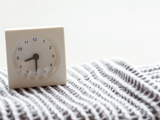Series of a simple white analog clock on the blanket, 8/15