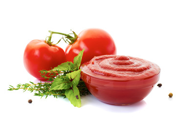 Bowl of ketchup or tomato sauce with ingredients on white