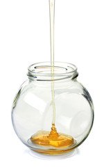 Jar with flowing honey on white