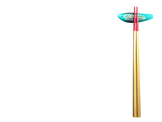 Gold and red chopstick and chopstick rest isolated on white background