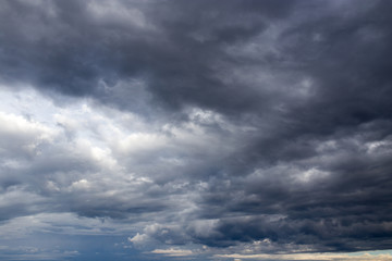 Naklejka na ściany i meble black clouds in the sky as the background