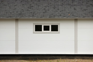 White wall texture house, dark windows, flexible brown tiles 