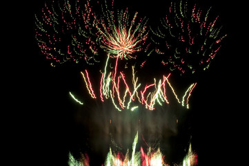 Fireworks display with reflections on the water