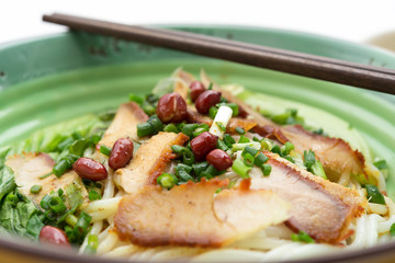 bowl of guilin rice noodles with chopsticks close up
