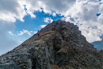 Girl tourist down the rocky slope