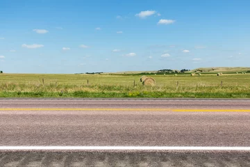 Fotobehang Hay bales and fields next to a road in northern Nebraska on a summer day.  © harmantasdc