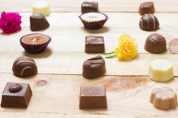 Chocolate candy set on wood background.
