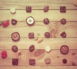 Chocolate candy set on wood background.