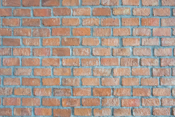 the old and dirty orange brick wall in warm or hot color tone/style with black stain for background texture