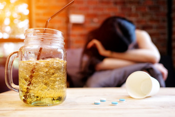 Young woman having headache sitting in a cafe 
