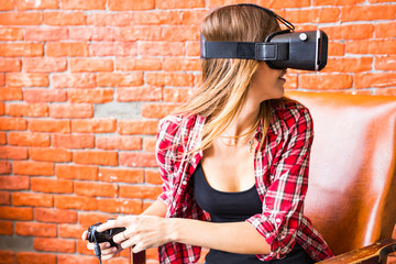 Fototapeta na wymiar technology, gaming, entertainment and people concept - young woman with virtual reality headset, controller gamepad playing racing video game.