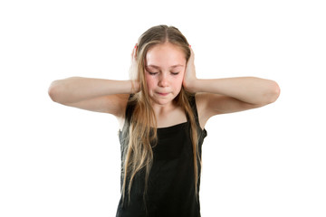 Obraz na płótnie Canvas Girl is closing ears with hands protecting from loud noise, isolated on white background.