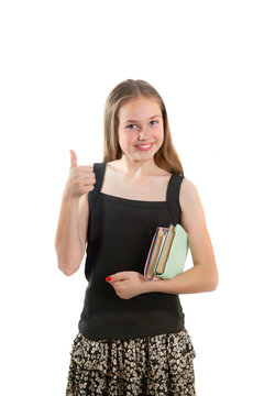 Happy school-girl with book giving thumbs up sign