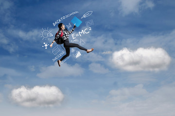 Obraz na płótnie Canvas Female student jumps on the sky