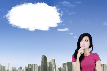 Pensive girl looking at cloud