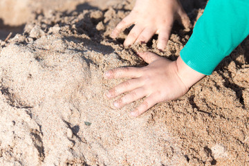 boy playing in the sand