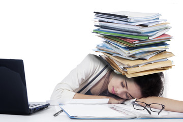 Young businesswoman sleeping with paperwork