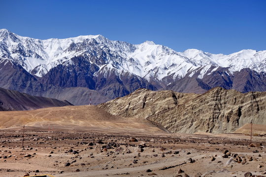 Snow mountain range at road side viewpoint on the way to Khardung La from Leh LADAKH, INDIA