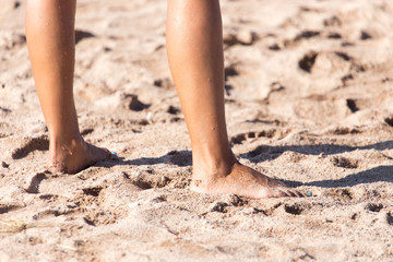 female legs on the beach