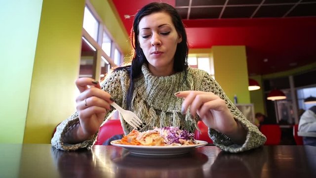 Woman Eating Turkish Doner Kebab In Cafe