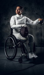 Fototapeta na wymiar Female fencer in wheelchair with safety mask and rapier.