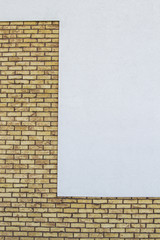 Modern brick wall with white painted plaster background