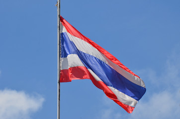 Thai flag with blue sky background.