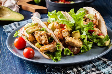 Authentic mexican tacos with chicken and salsa with avocado, tomatoes and chillies