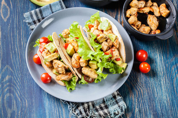 Authentic mexican tacos with chicken and salsa with avocado, tomatoes and chillies