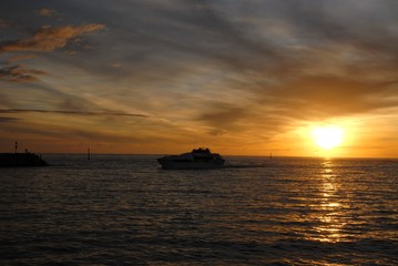 Naklejka na ściany i meble sunset with passenger ferry