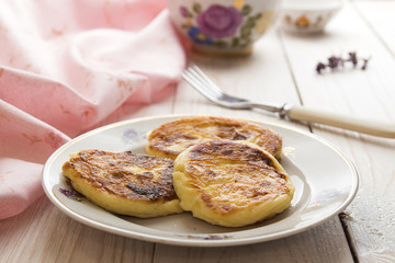 Cottage cheese pancakes on plate with flowers