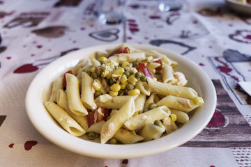salad of pasta with peas, corn, tuna and tomato