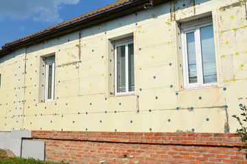 Close up on Thermal House Insulation Exterior. Facade Wall Insulation with Styrofoam, Polystyrene with Stucco for House Energy Saving Outdoor.