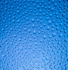 Abstract rain dropson blue background