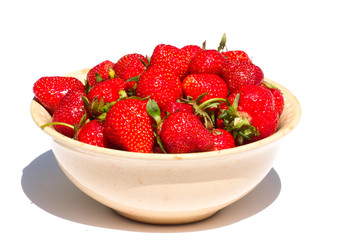 Raw strawberries lying in plate isolated on white background.