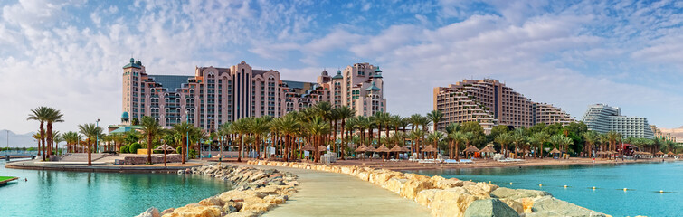 Central public beach of Eilat at sunset. Eilat is a famous resort city in Israel - obrazy, fototapety, plakaty
