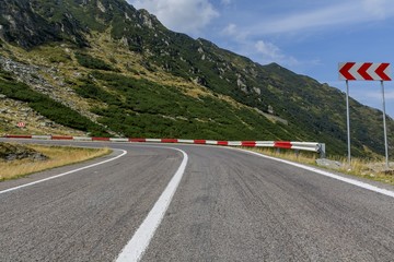Winding mountain road with dangerous curves in Carpathian mountains. Transfagarasan  road in Romania.