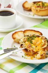 Baked sandwich with egg, cheese and ham.