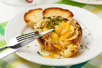 Baked sandwich with egg, cheese and ham.
